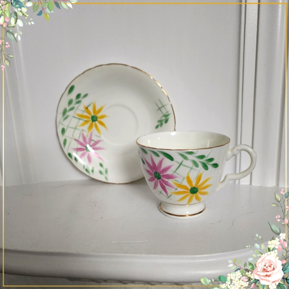 Delphine Tea cup and saucer England Fine bone china Pink & yellow flowers green